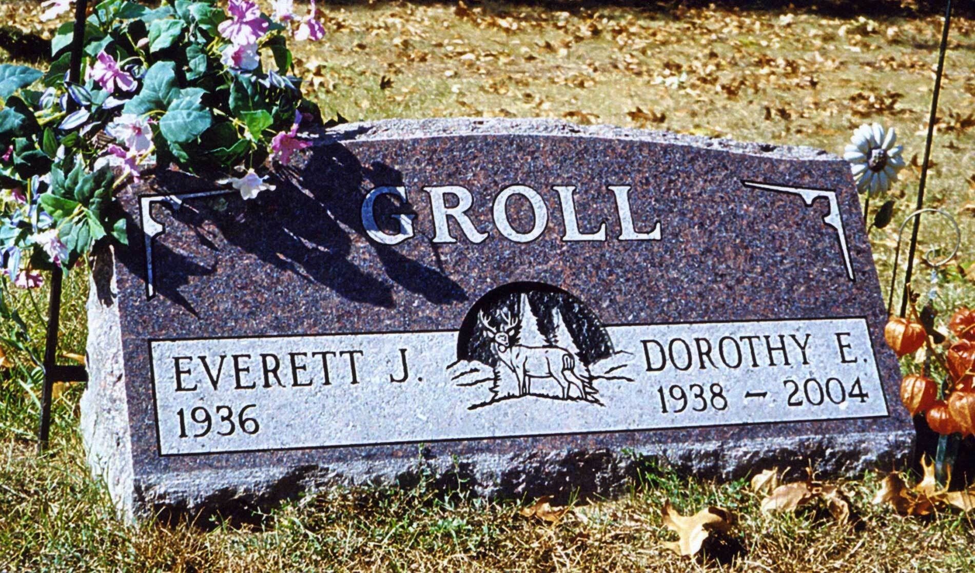 Gray granite gravestone marked Groll with flowers, Everett J. 1936–1995 and Dorothy E. 1938–2004.