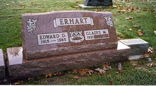 Brown gravestone engraved “TERHART,” with names Edward and Gladys in a grassy cemetery.
