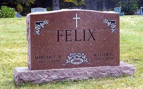Brown granite gravestone with cross and the name Felix in a grassy cemetery.