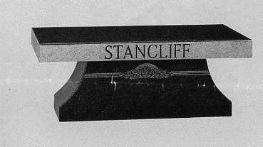 Black-and-white photo of a Stancliff weight bench with a rectangular padded top and curved base.