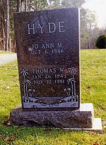 Gravestone marked “HYDE” with two names and dates, set on a grassy lawn in sunlight