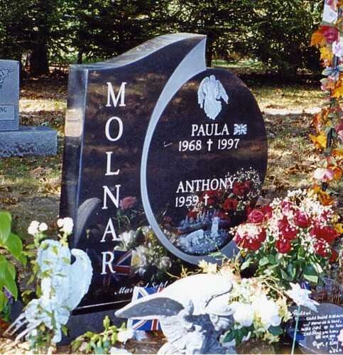 Black gravestone with flowers, memorializing Molnar, Paulla, and Anthony in a cemetery
