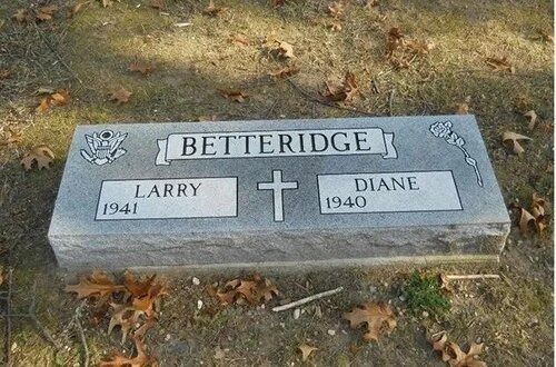 Gray gravestone in a cemetery engraved “Betteridge,” with names Larry and Diane and a cross between them