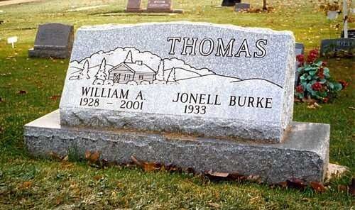 Thomas family gravestone in a grassy cemetery, engraved with William A. Thomas and Jonell Burke.
