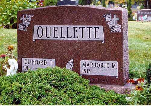 Brown granite gravestone engraved “OUELLETTE,” with Clifford T. and Marjorie M. markers amid greenery.