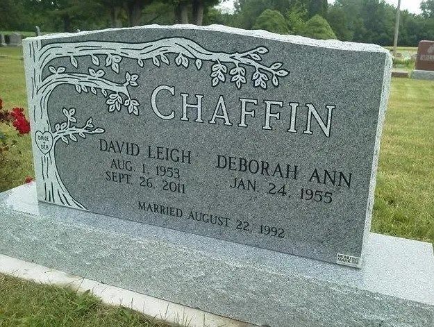 Gray gravestone engraved “CHAFFIN” with floral design in a cemetery