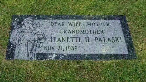Gray gravestone on grass engraved “Dear Wife, Mother, Grandmother Jeanette H. Palaski, Nov. 21, 1939.”