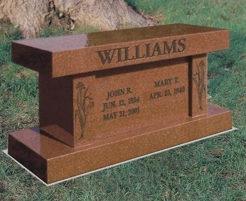 Rust-colored memorial bench grave marker with the name WILLIAMS engraved on top