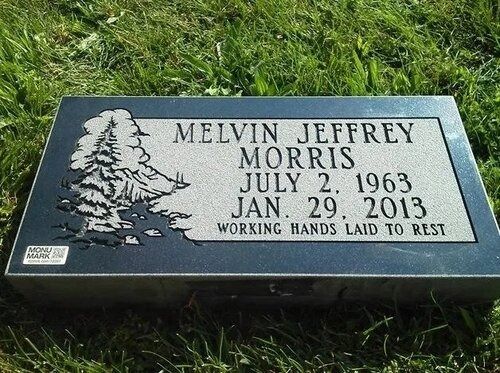 Memorial gravestone on grass reading “Melvin Jeffrey Morris, July 2, 1963–Jan. 29, 2013”