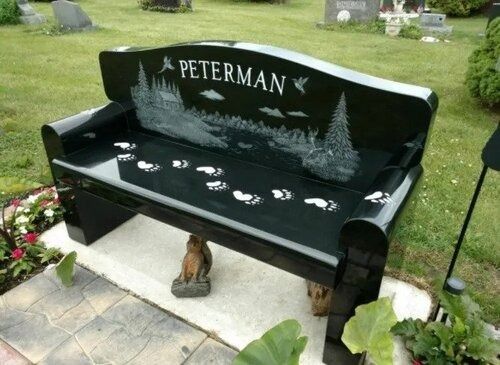 Black engraved memorial bench with the name 