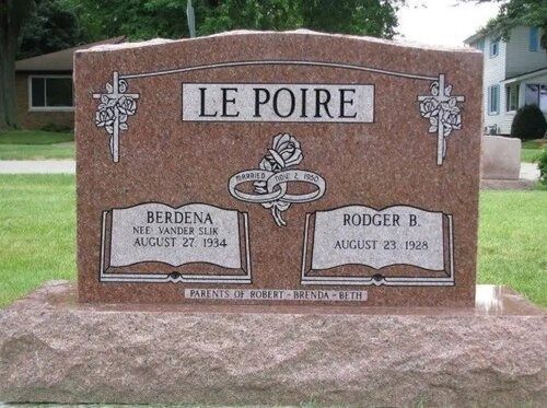 Le Poire gravestone with two plaques and decorative cross in a cemetery setting