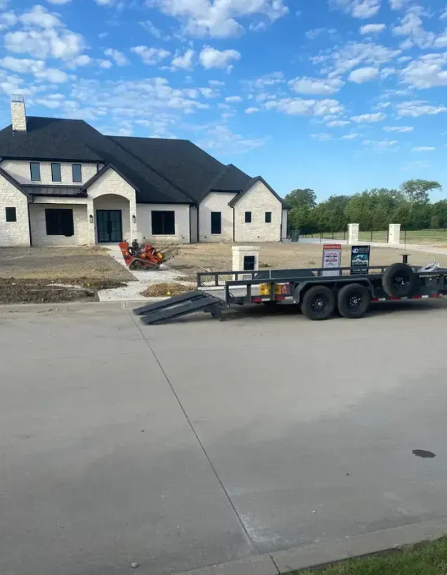 Trailer parked in front of a new house under construction on a clear day