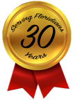 A gold medal with the number 30 on it and a red ribbon.