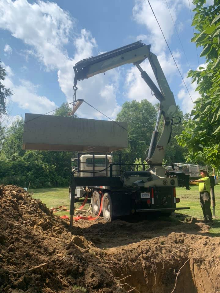 Excavator Lifting Septic Tank - Flushing, MI - Don’s Septic Services