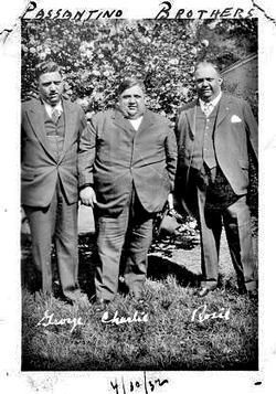 Three men in suits, Passantino Brothers, posed outdoors. Text at bottom: George, Charlie, Rossi. Dated 4/30/30.
