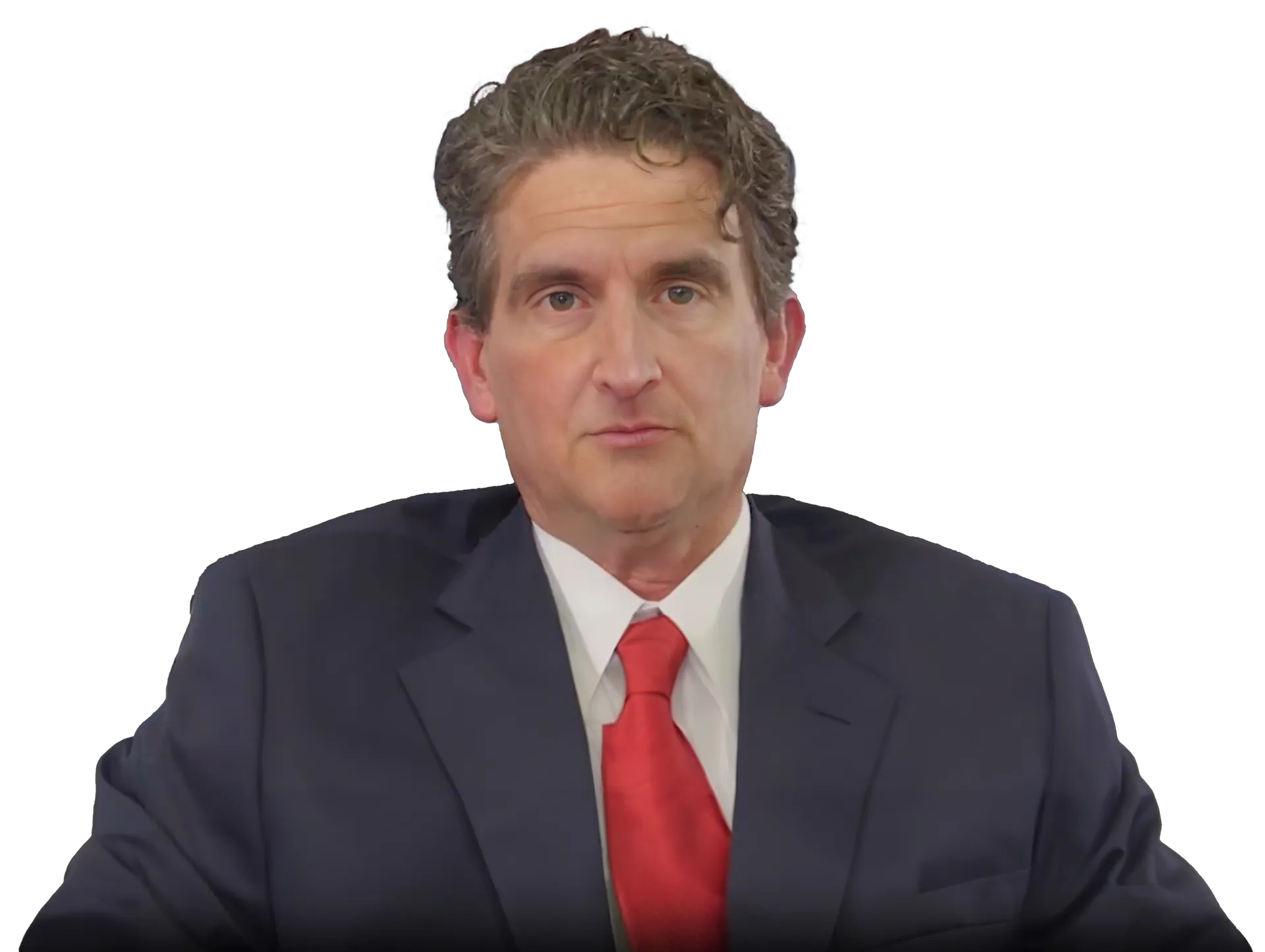 A person with wavy brown hair wears a dark blue suit and a bright red necktie against a plain white background.