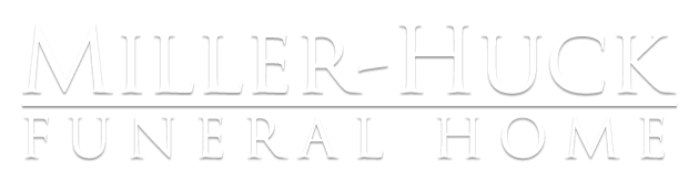 Miller-Huck Funeral Home sign in embossed white lettering on a white background