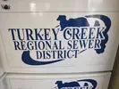 Truck with “Turkey Creek Regional Sewer District” logo on a white vehicle body