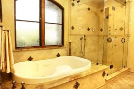 A bathroom with a tub , shower and window.