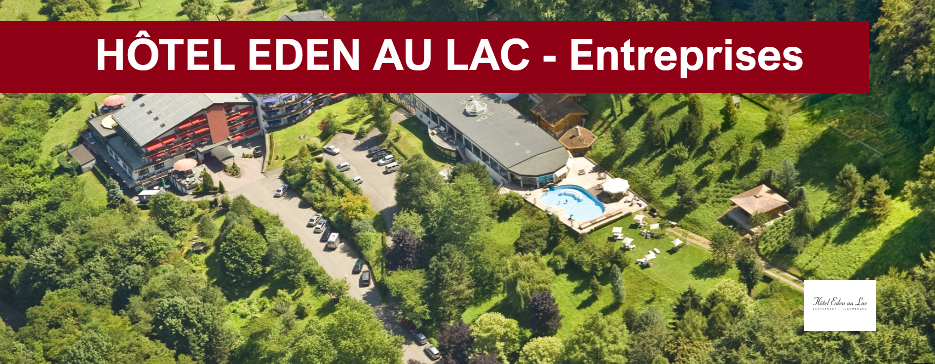 Vue aérienne de l'hôtel Eden au Lac dans un cadre verdoyant, comprenant une piscine et des arbres.