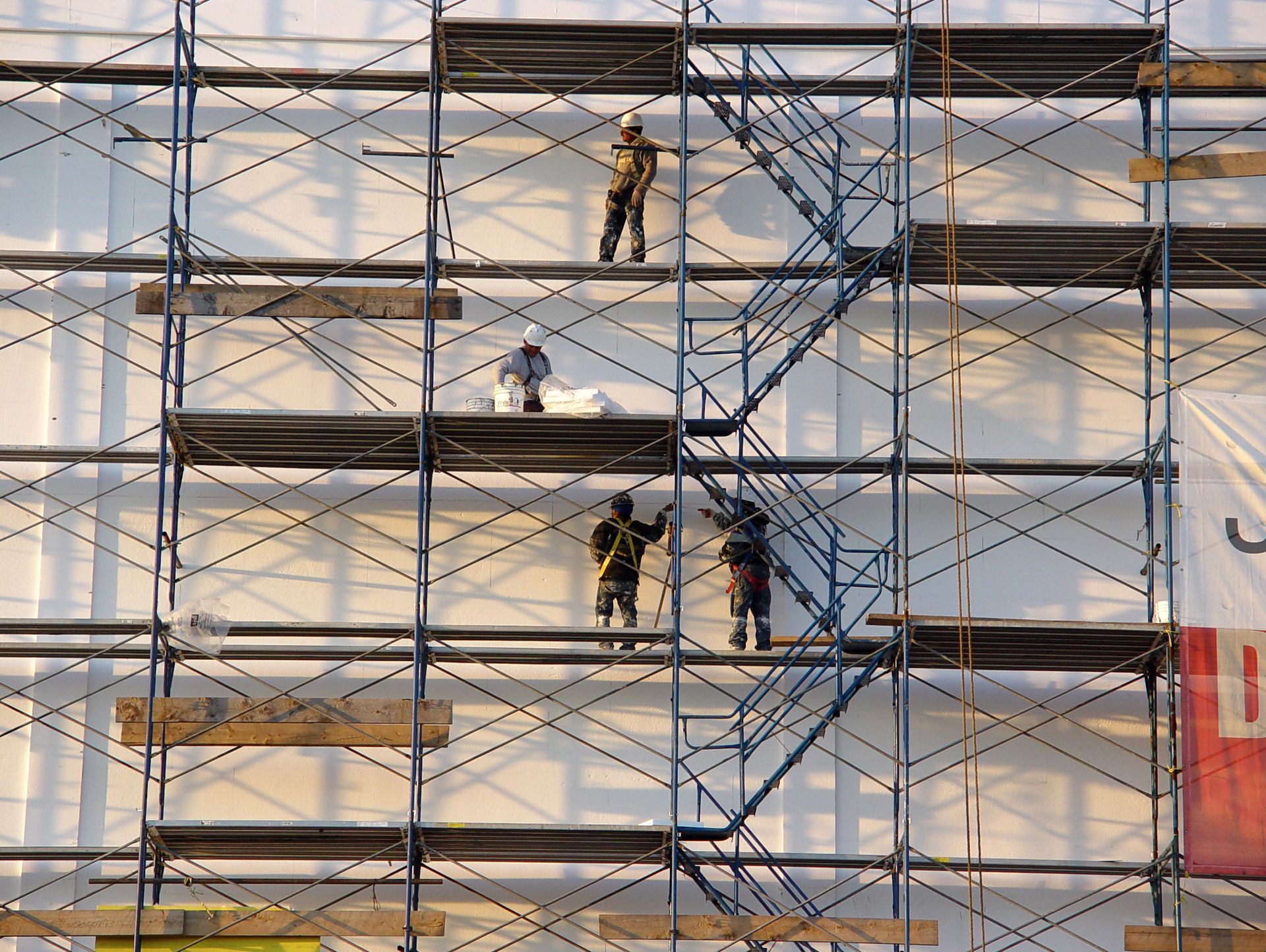 Several men on scaffolding  in a Commercial Construction