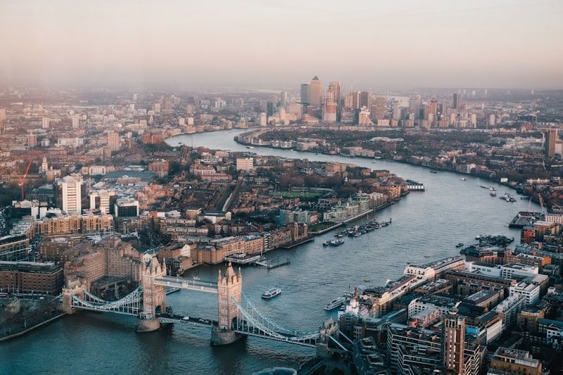 Aerial view of London with Tower Bridge over the River Thames at dusk, city skyline in the background