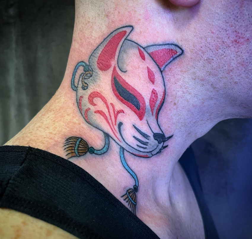 Stylized fox tattoo in pink and red on the side of a neck, with a blue cord detail