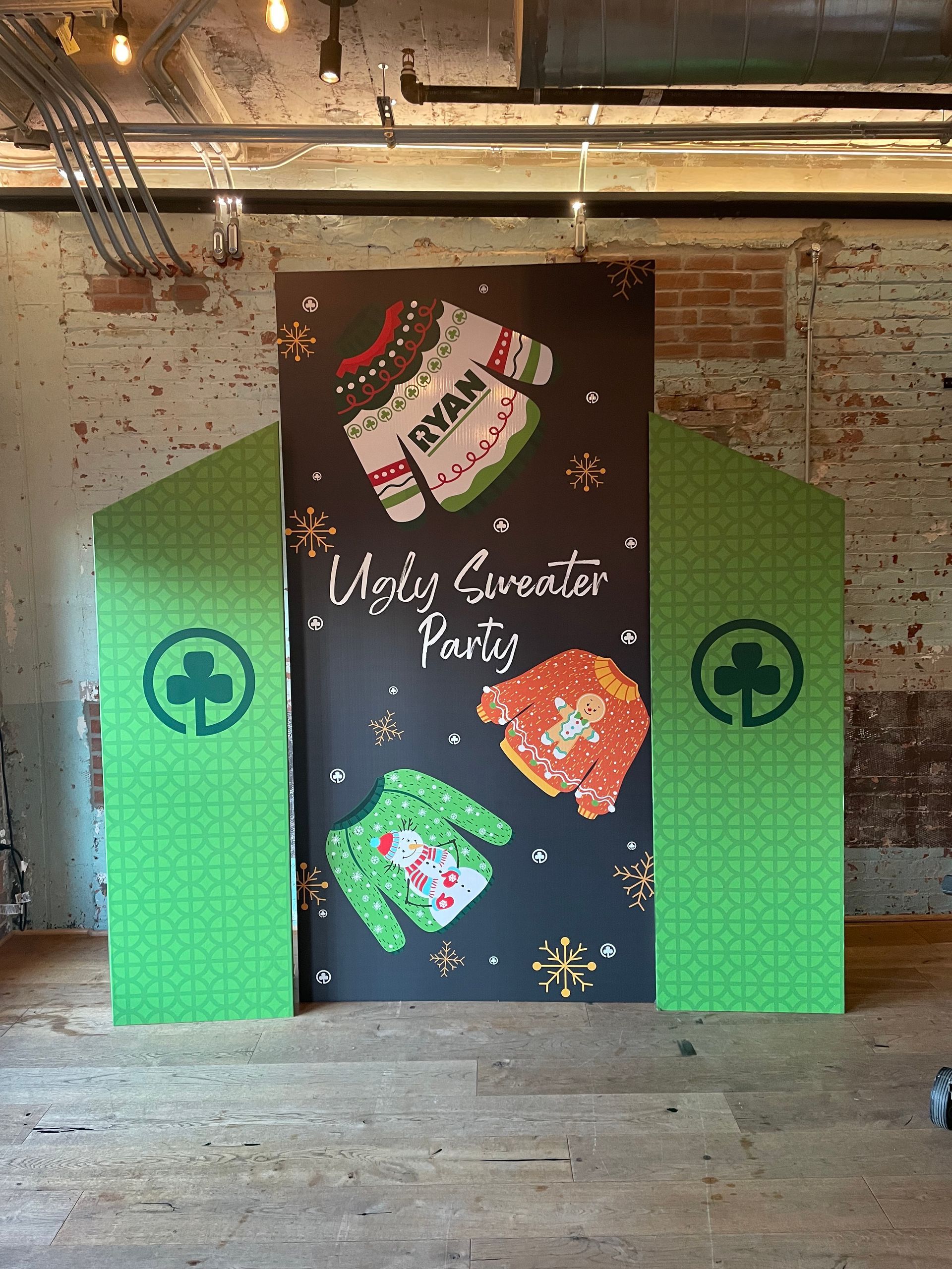 Holiday themed backdrop with stockings and festive décor for Christmas party photo area
