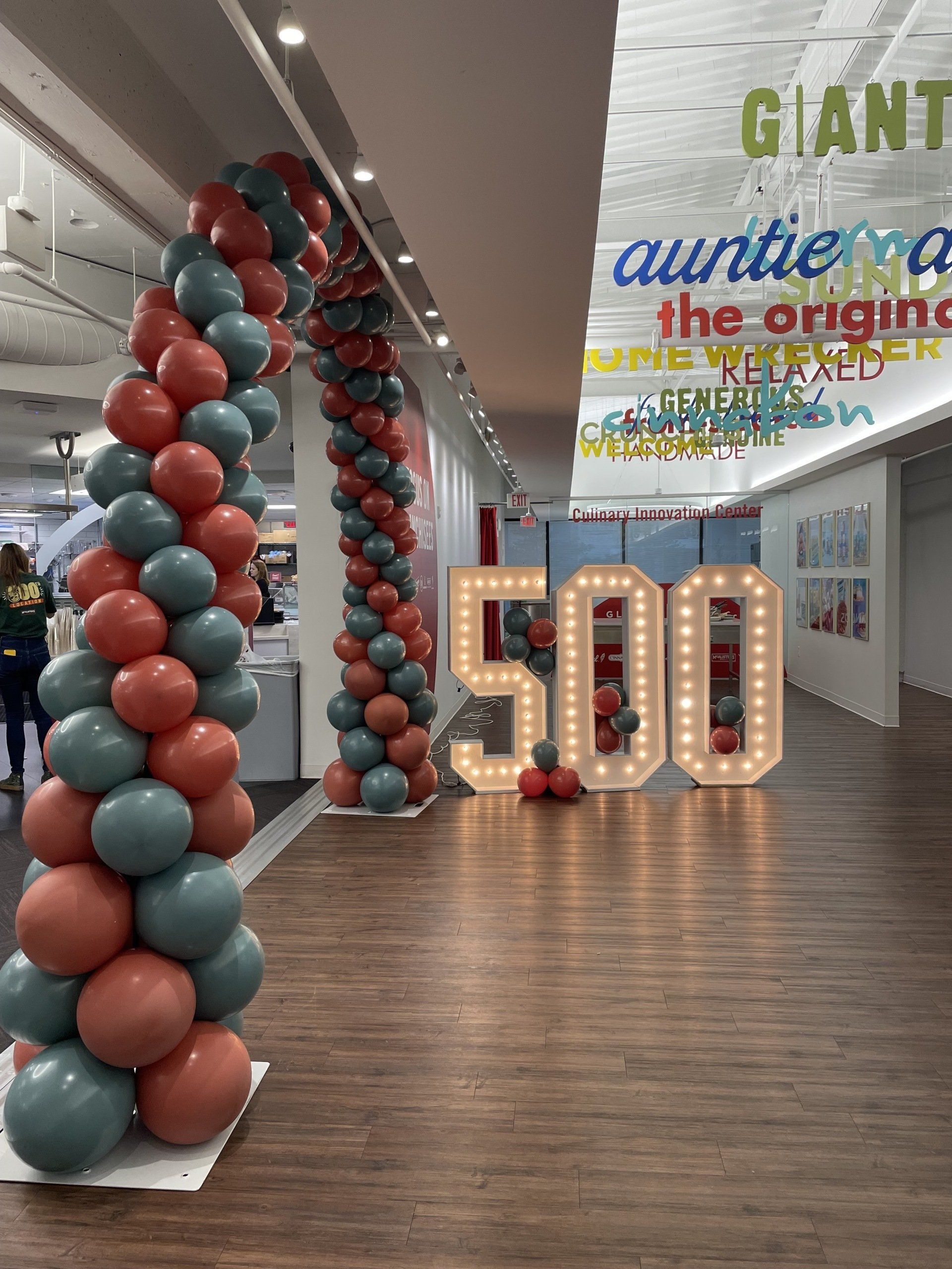 Large balloon column installation lining a hallway for an indoor corporate or school event