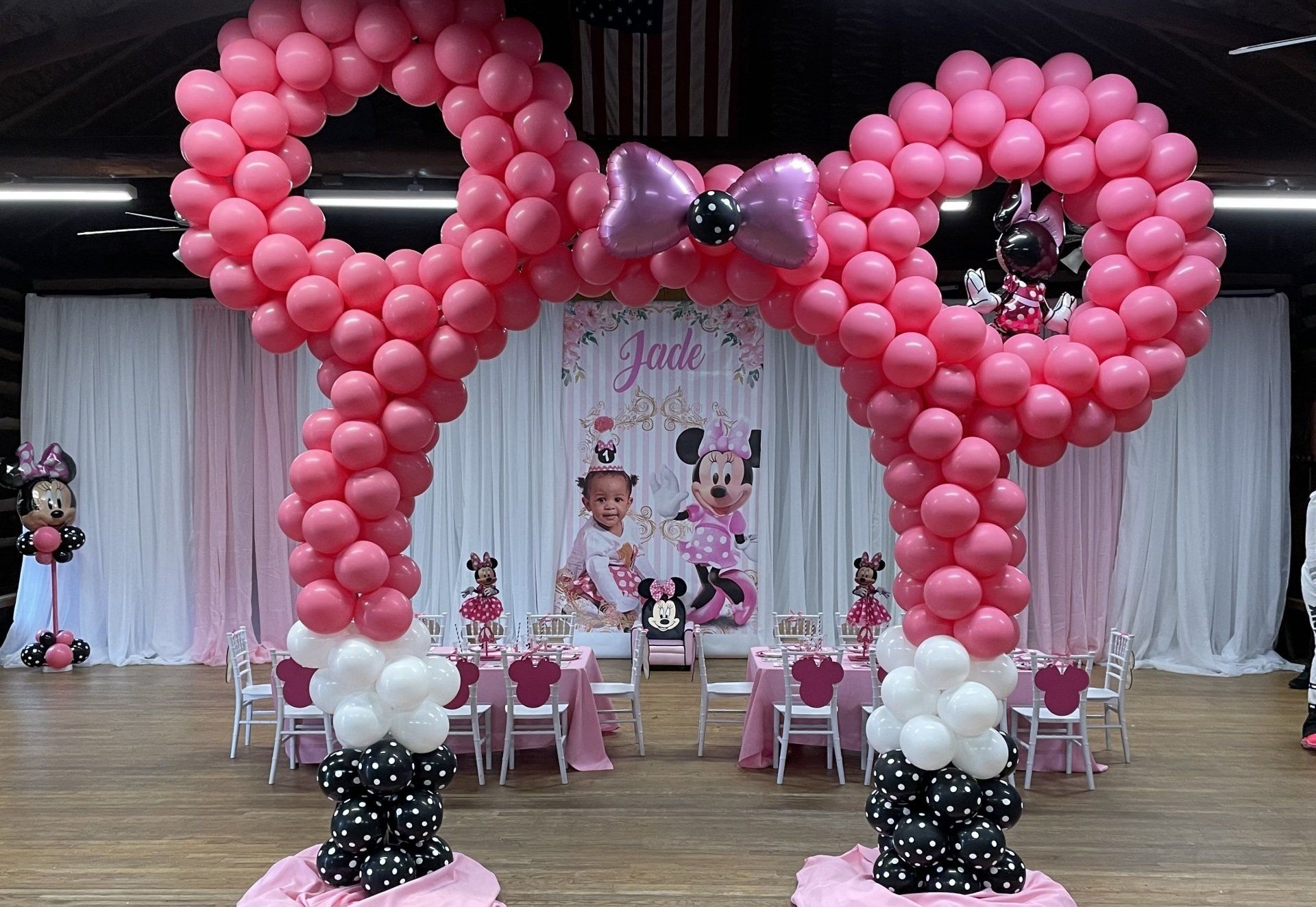 Pink Minnie Mouse–inspired balloon arch backdrop for a children’s birthday party