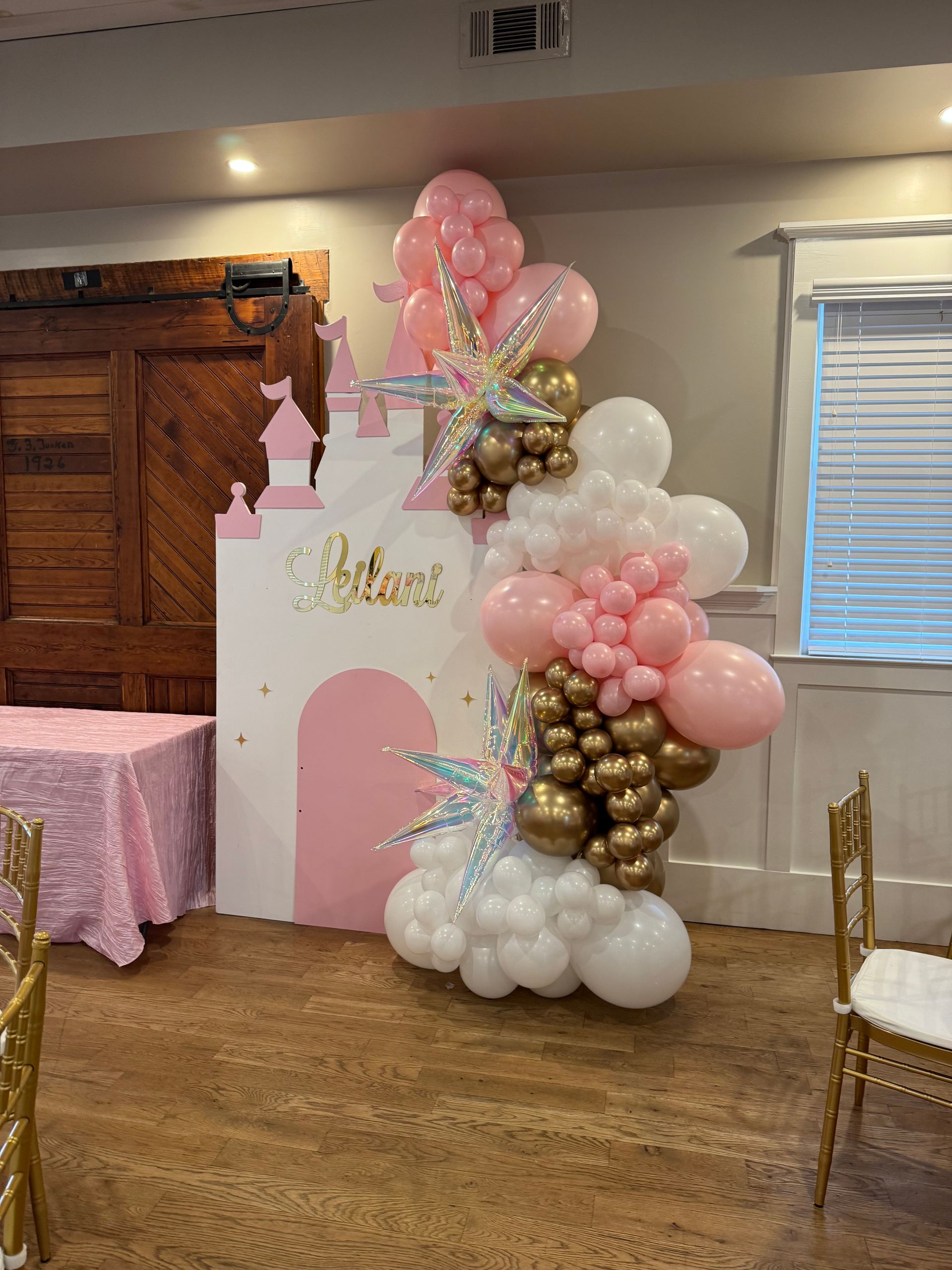Soft pink white and gold balloon cluster with princess castle cutouts for girls birthday party décor