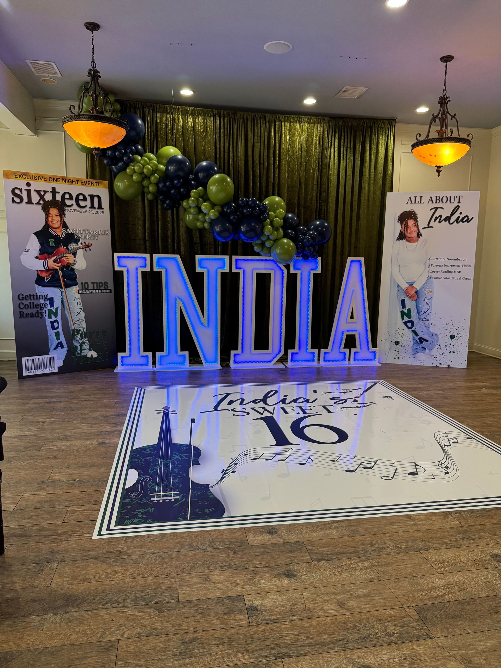 Sweet sixteen backdrop with green draping and marquee letters