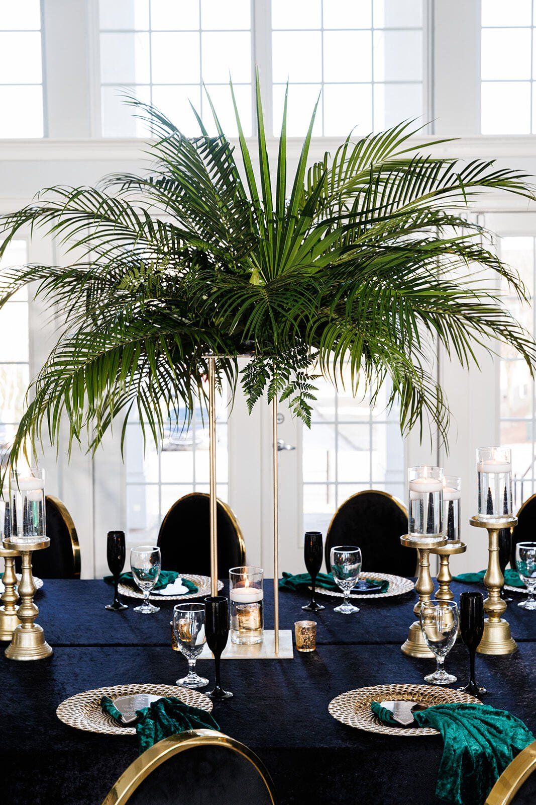 Tall potted palm greenery placed near windows for natural event décor styling