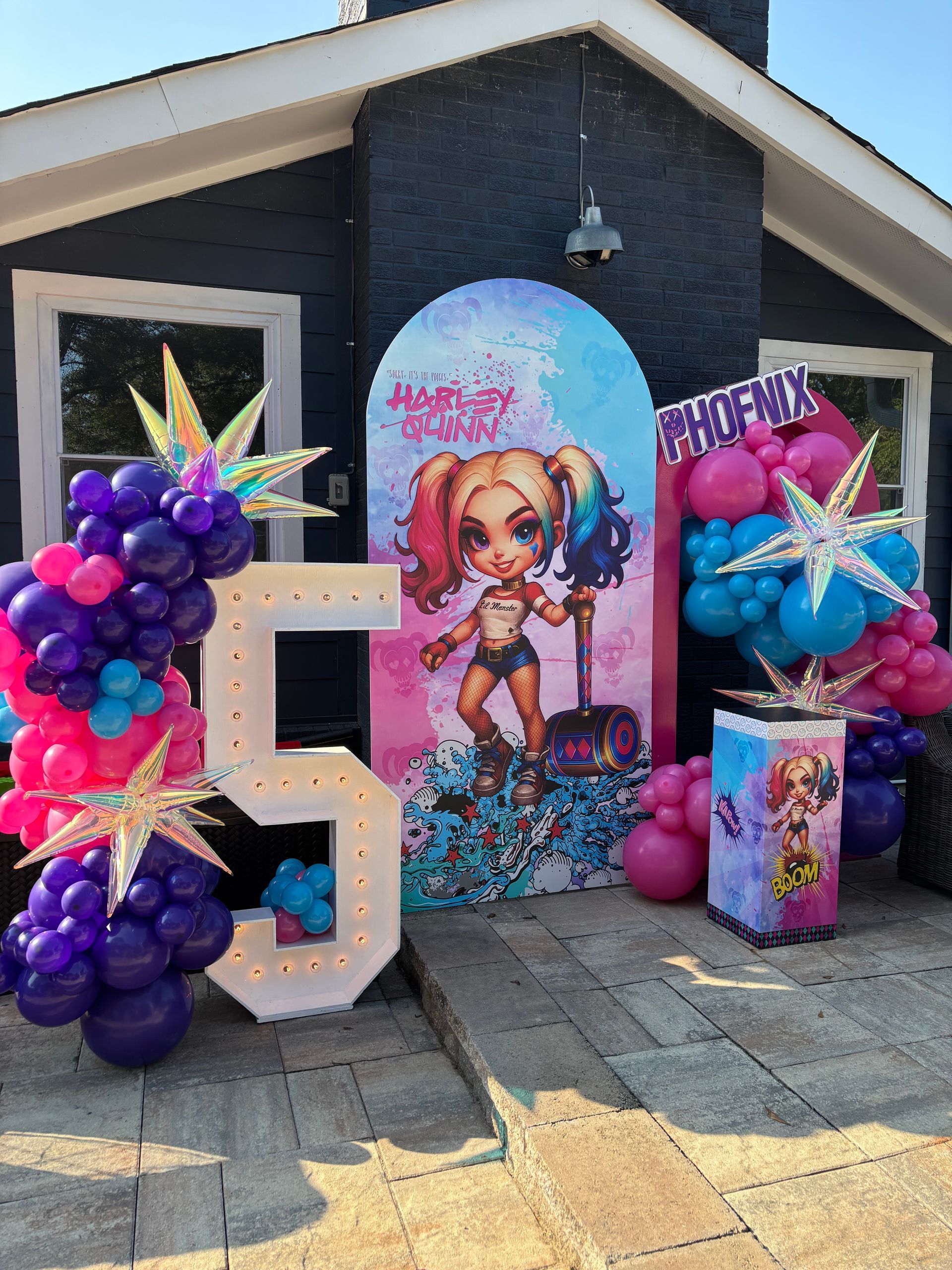 Colorful outdoor balloon display with character backdrop and bright themed décor for kids birthday party
