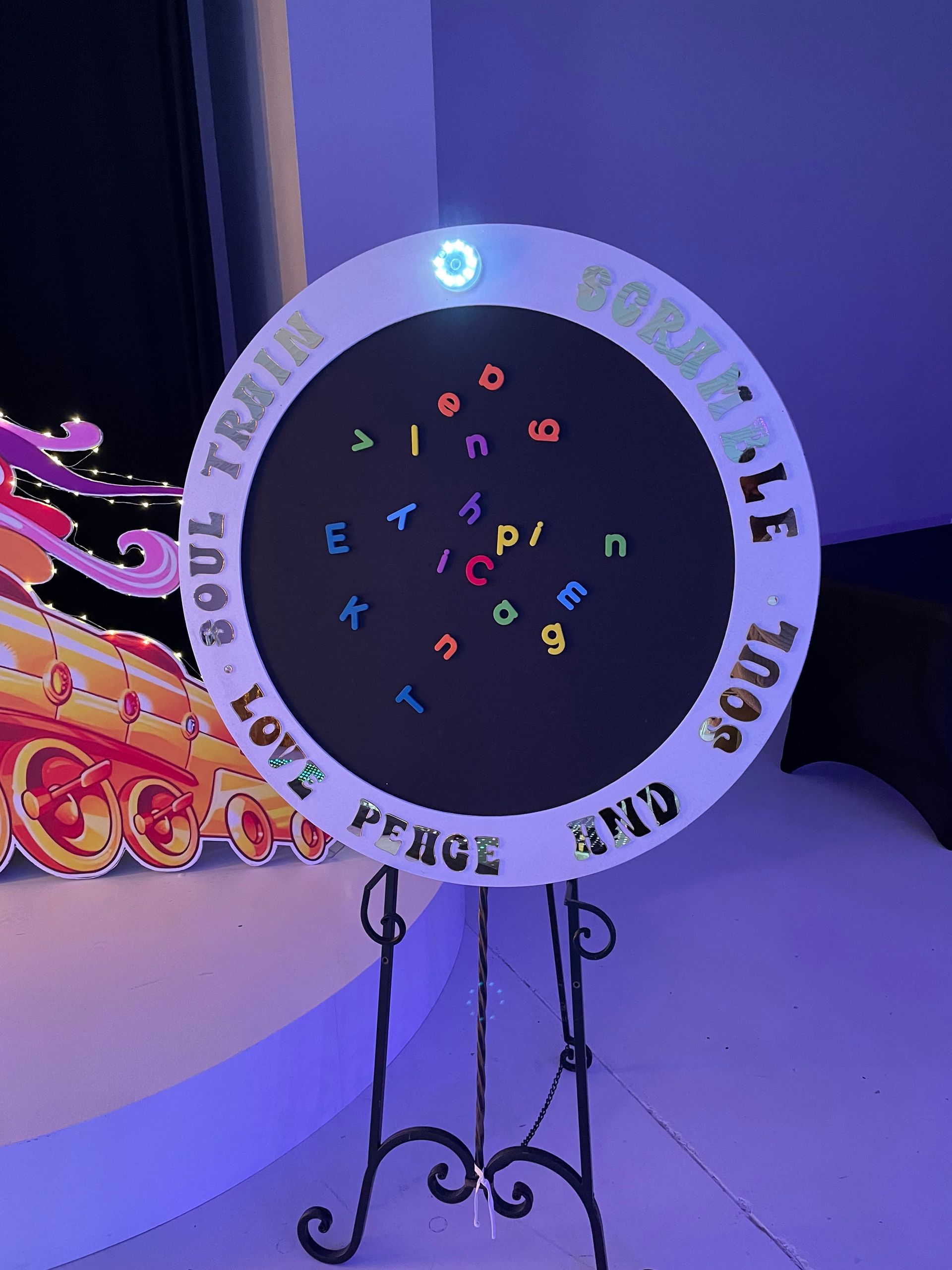 Soul Train themed circular event sign with retro lettering and purple lighting
