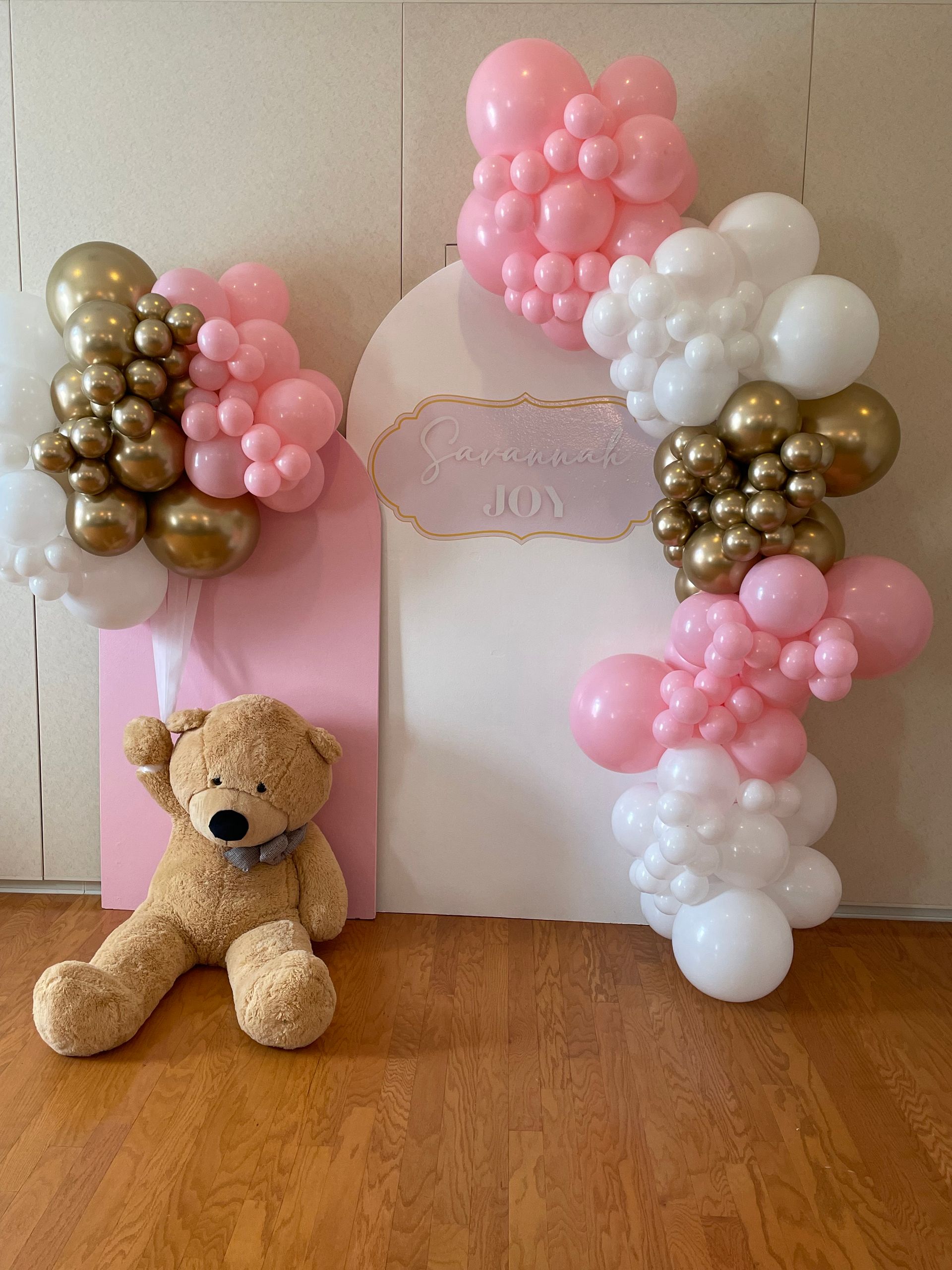 Rose gold and blush balloon arch with illuminated marquee numbers for sweet 16 birthday celebration