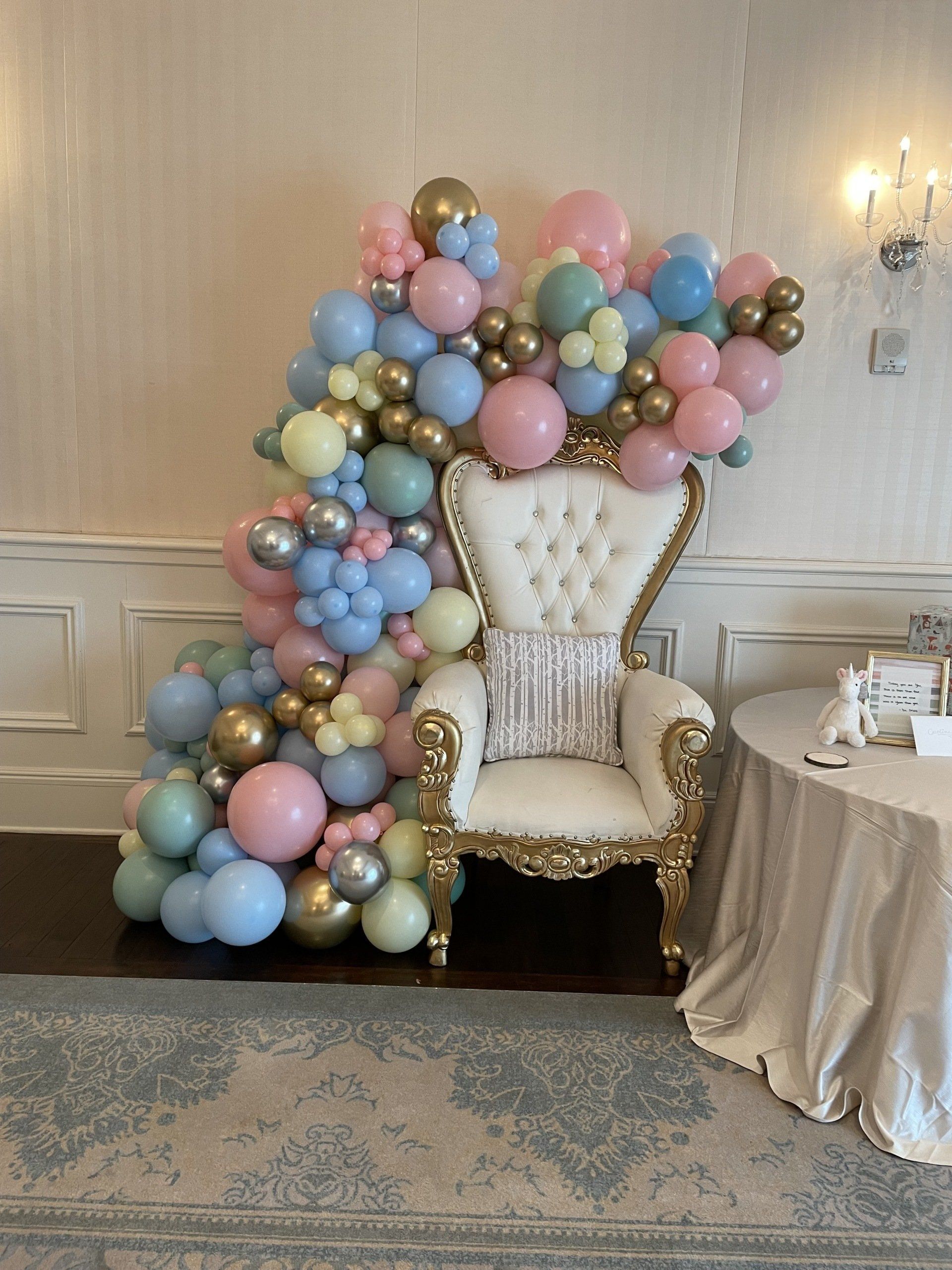 Pastel balloon cluster backdrop with blush blue and gold balloons for baby shower or birthday party
