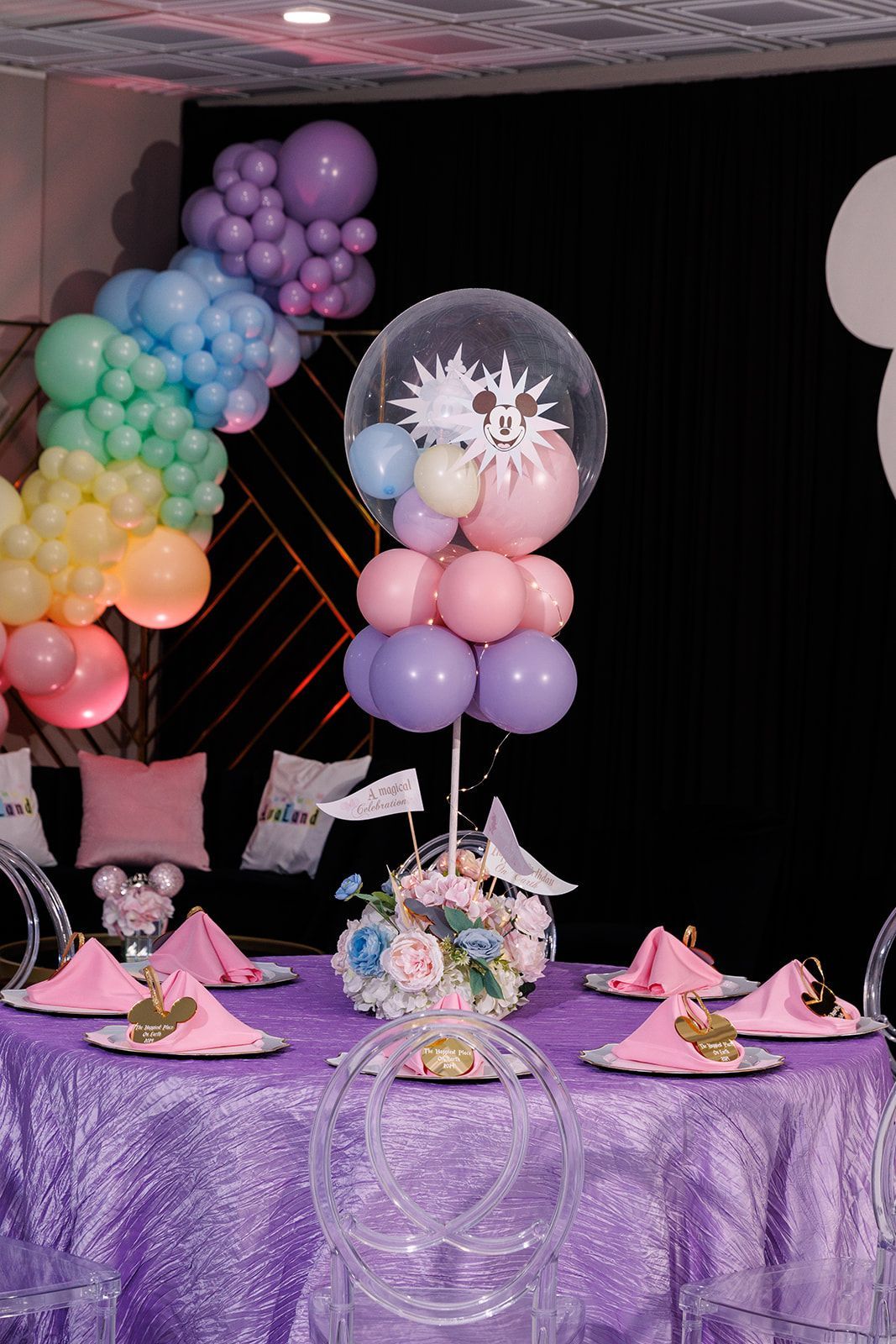 Colorful rainbow balloon garland with oversized clear bubble balloon backdrop for birthday or kids party décor