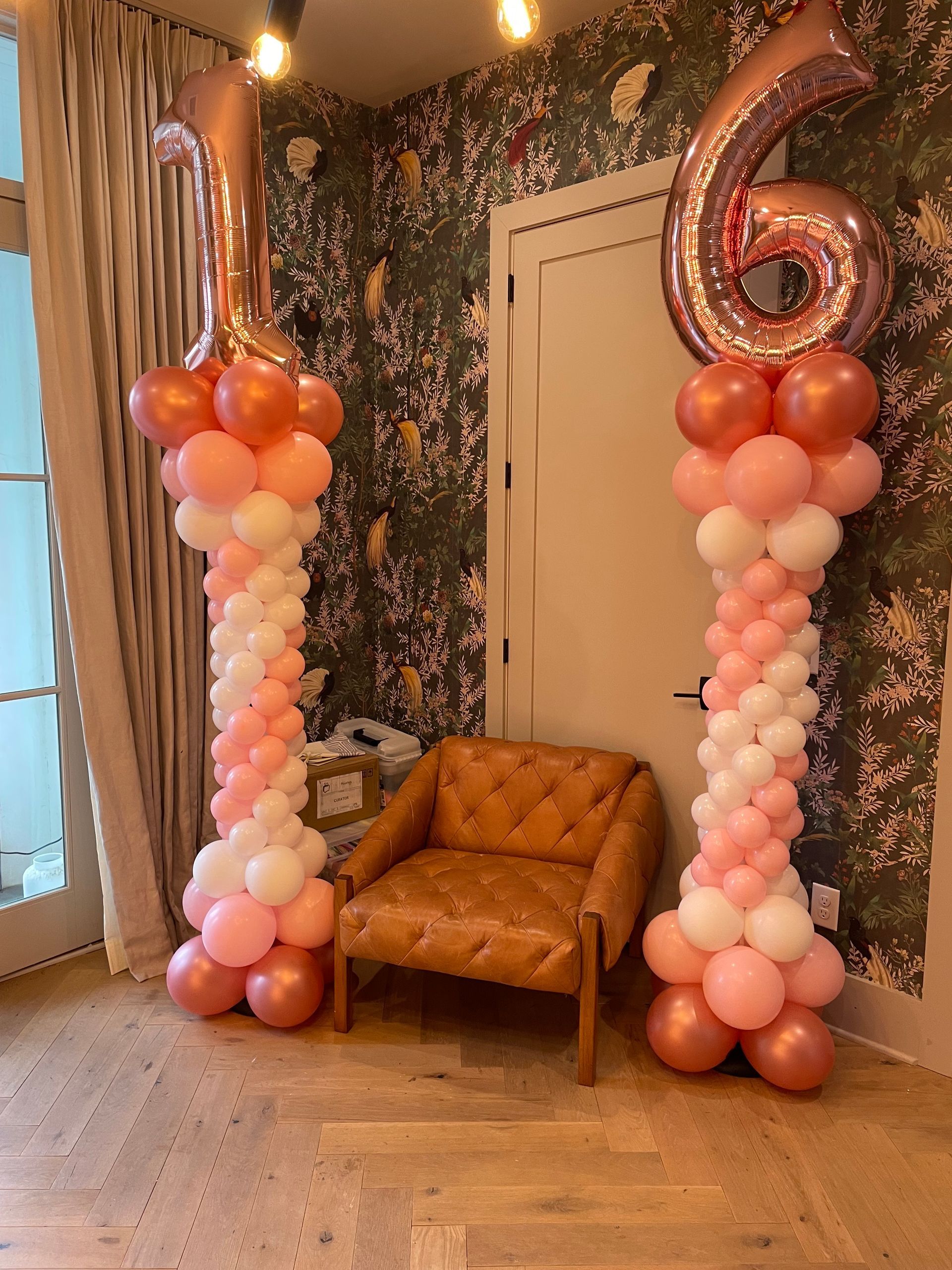 Rose gold number balloon columns displaying 16 for a birthday celebration indoors