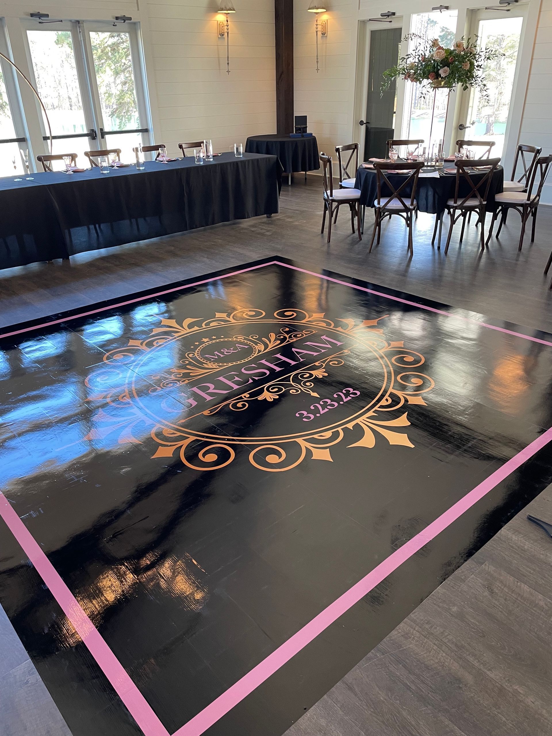 Event venue with banquet tables, chairs, and dance floor setup for wedding or corporate reception
