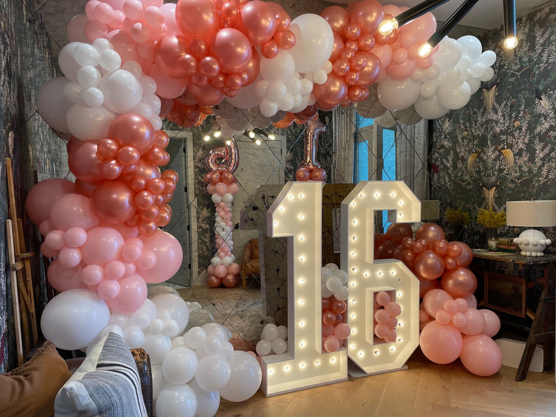 Blush peach and brown organic balloon clusters around custom baby shower backdrop display