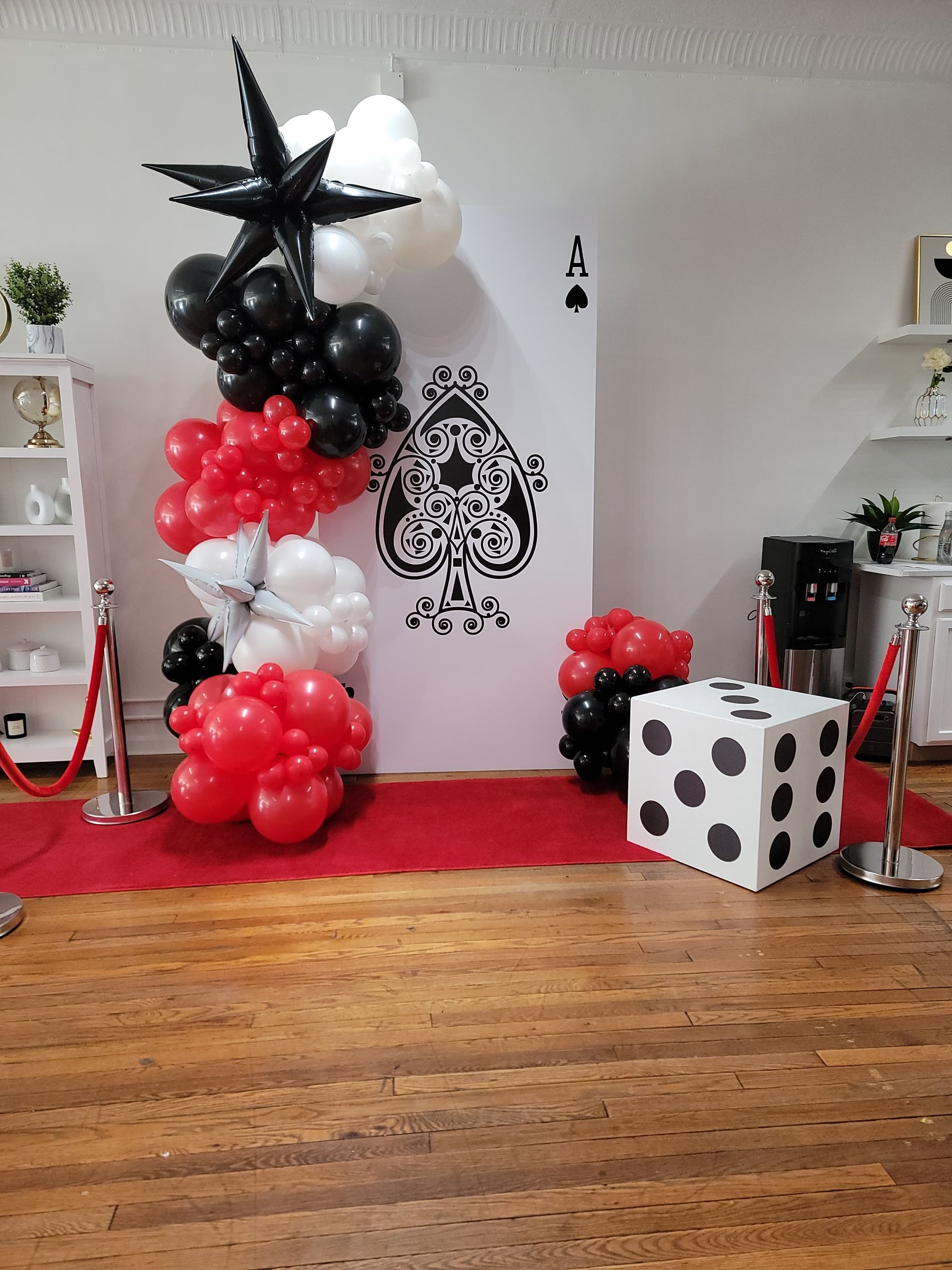 Black red and white balloon column with oversized star balloon for casino or card themed party