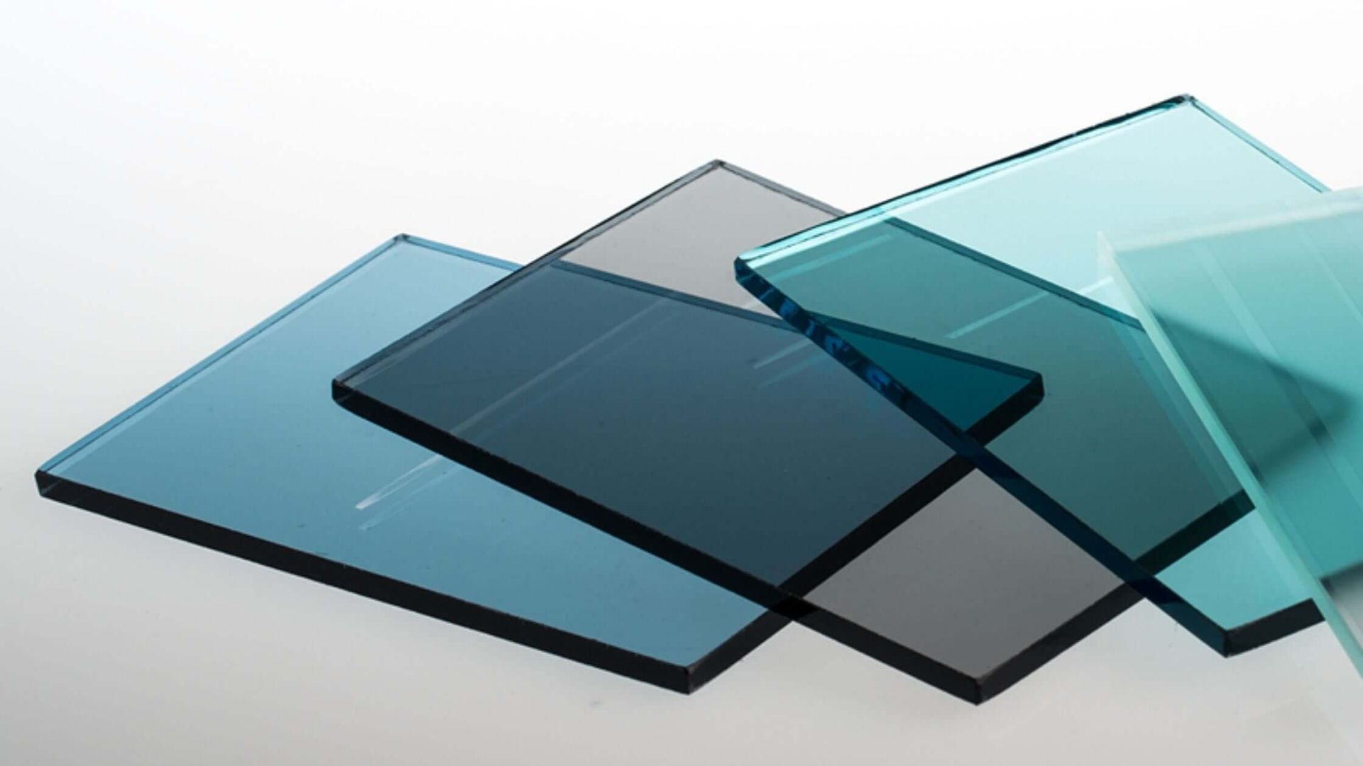 Colored glass samples, overlapping. Shades of blue, teal, and gray.