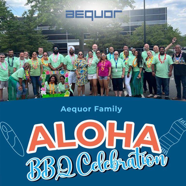 Aequor Family group photo at an ALOHA BBQ Celebration banner outdoors