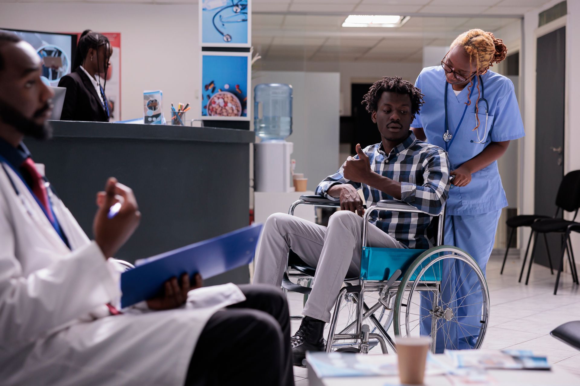 Doctor consulting with a patient in a wheelchair in a hospital waiting room