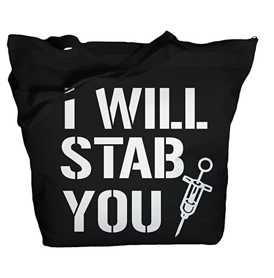 Black tote bag with bold white text reading “I WILL STAB YOU” and a syringe graphic.