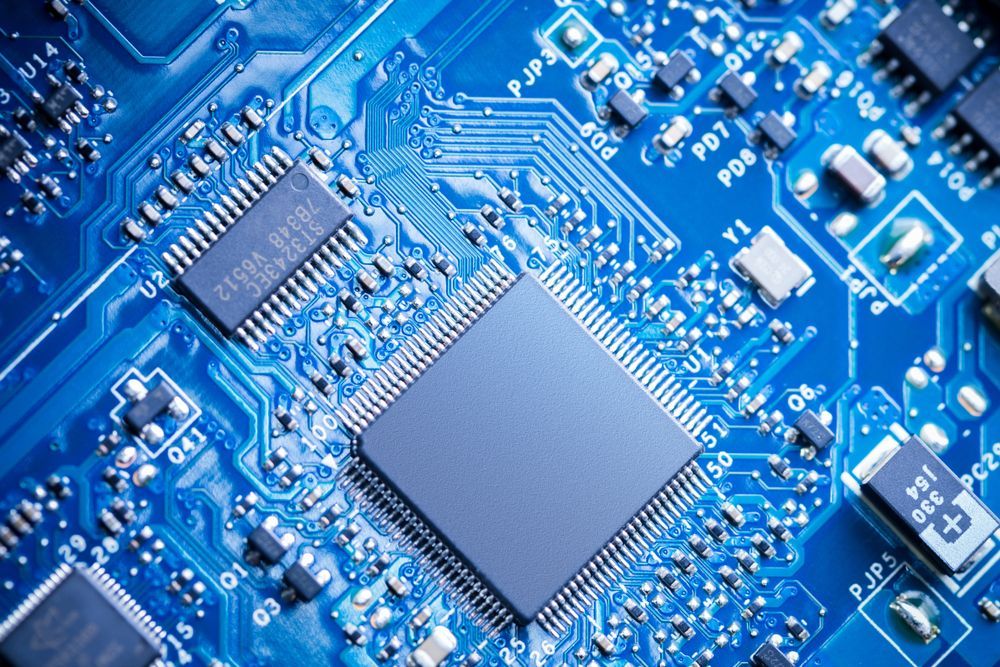 Close-up of a blue circuit board with electronic components.