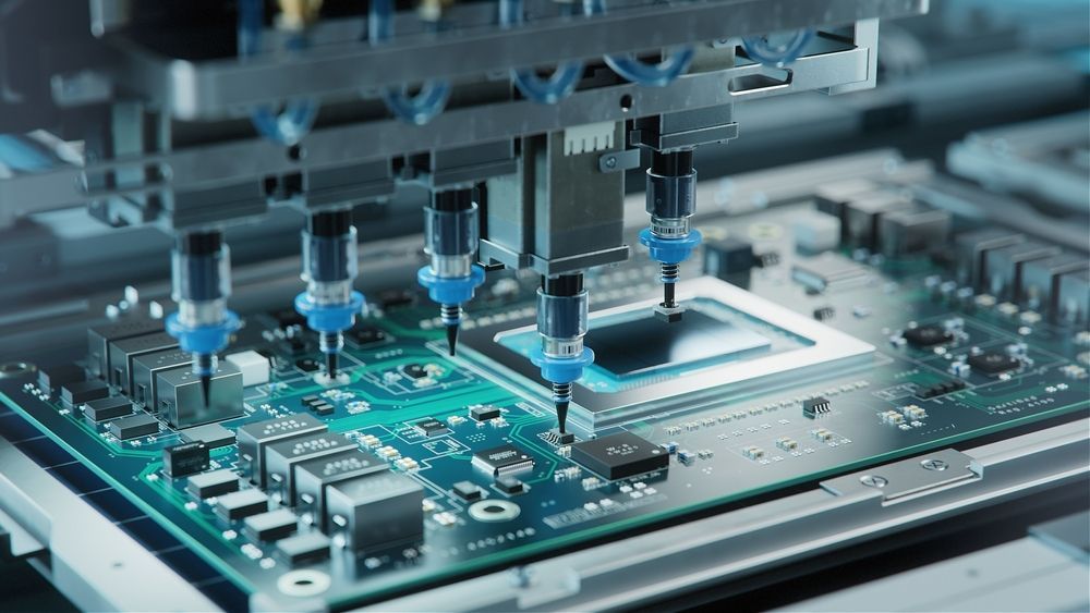 Robotic arms assembling a green circuit board with microchips and components.