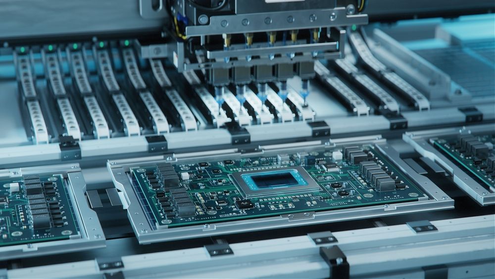 Assembly line placing components on circuit boards.