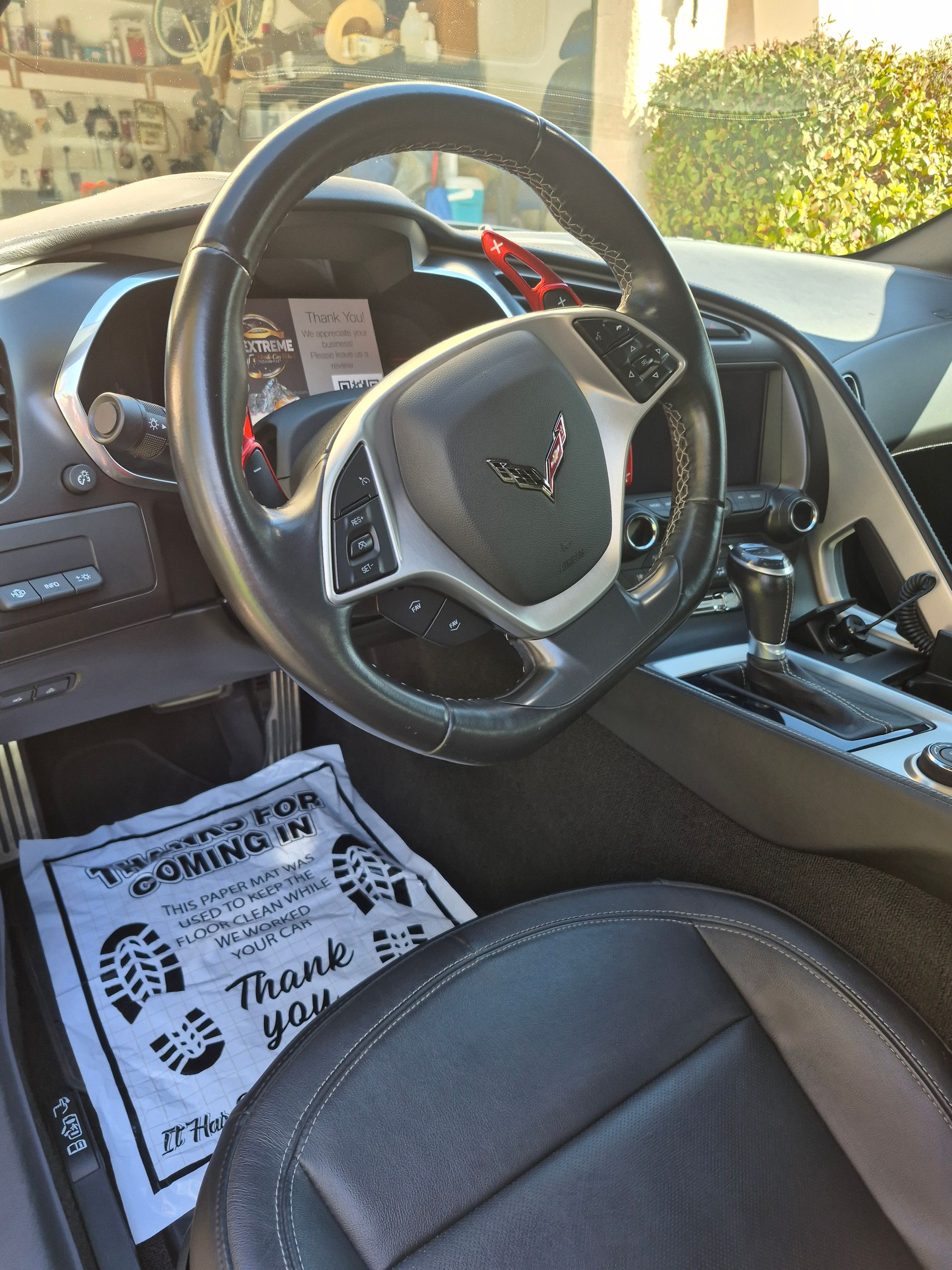 A gray house with a blue door and windows
